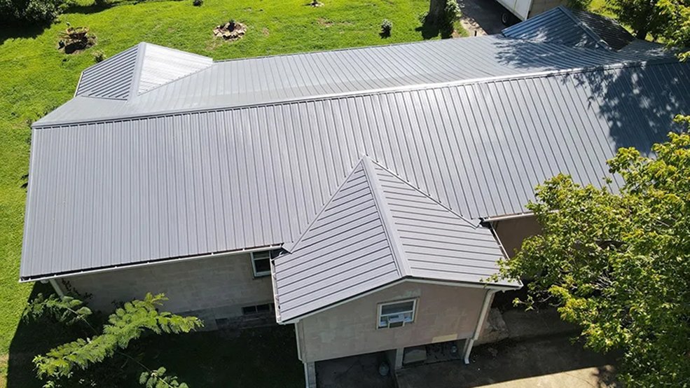 Gray traditional metal roof panels in daylight
