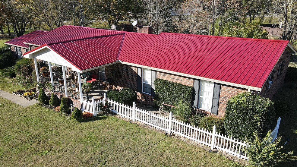 Red traditional exposed fastener metal roof panel