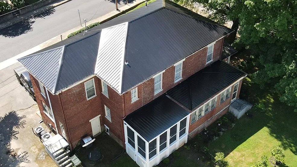 Black traditional metal roofing panels and seams