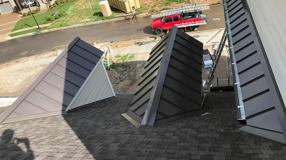 Black standing seam metal roof across multiple gables