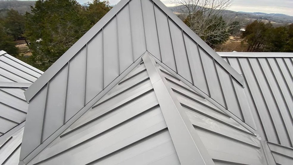 Gray standing seam metal roof on an angular roofline