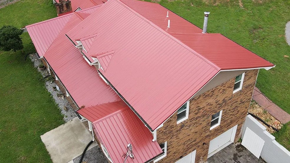Red traditional metal roof panels and ridge