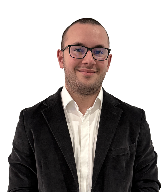 Man with short hair and glasses wearing a white shirt and black blazer smiling at the camera.