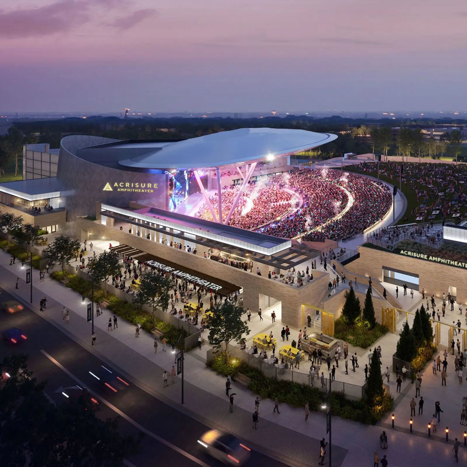 Aerial view of the Acrisure Amphitheater at dusk with a large crowd attending a concert under a modern curved roof.