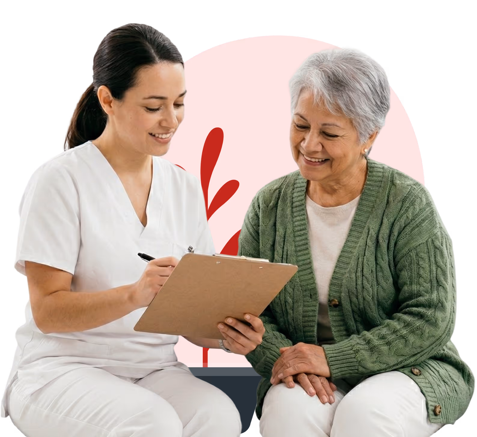 A nurse in white scrubs smiles while holding a clipboard and talking with a smiling elderly woman in a green sweater.