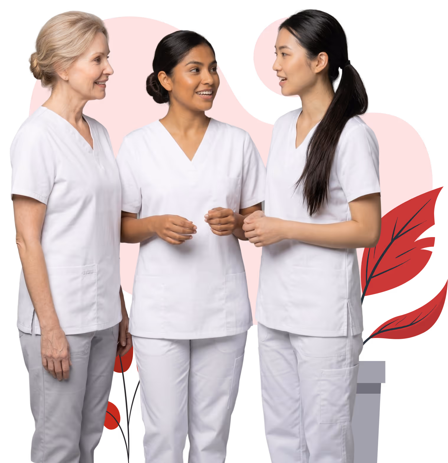 Three female healthcare workers in white scrubs standing and talking with each other.