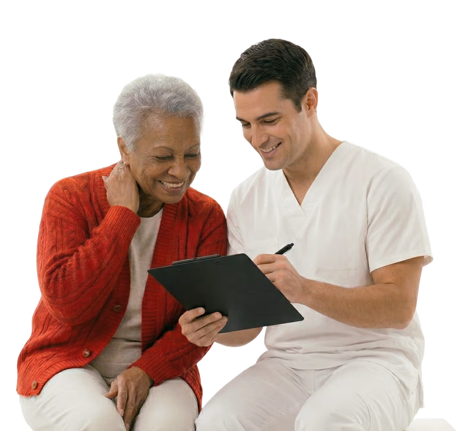 Smiling elderly woman in red cardigan sitting next to a male healthcare professional in white scrubs who is holding a clipboard and pen.