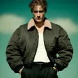 A man in a black jacket and white shirt.