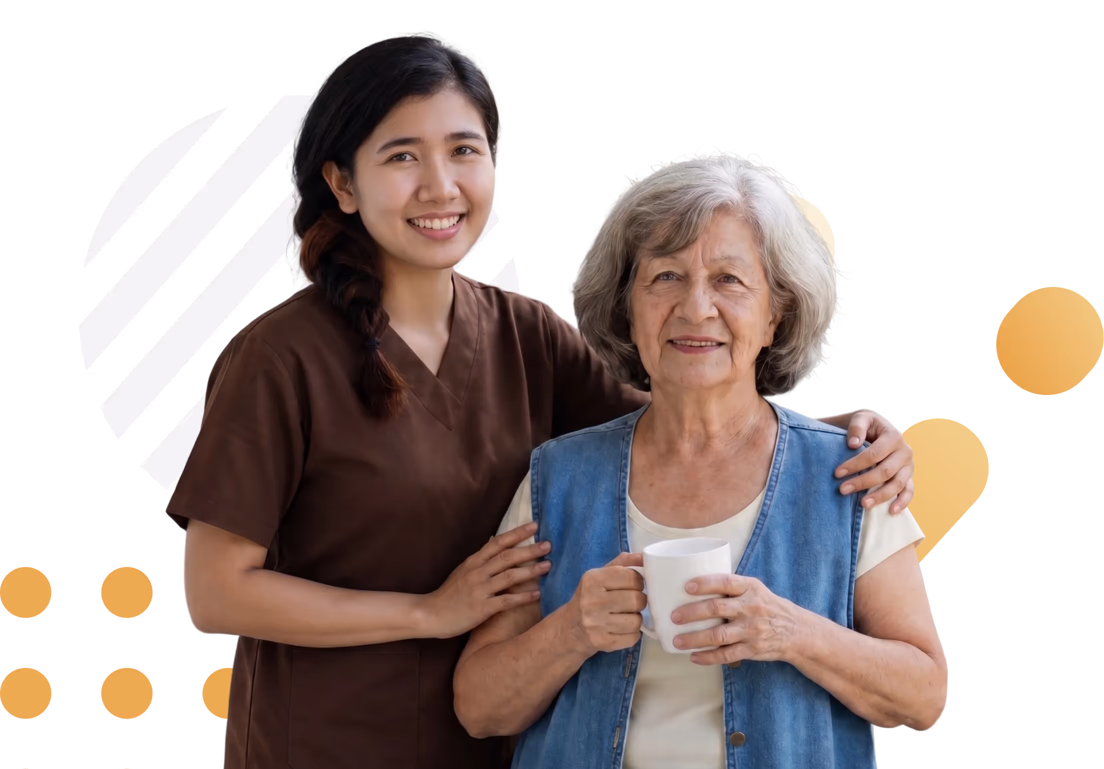 Smiling young caregiver with arm around elderly woman holding a white mug, both facing the camera.