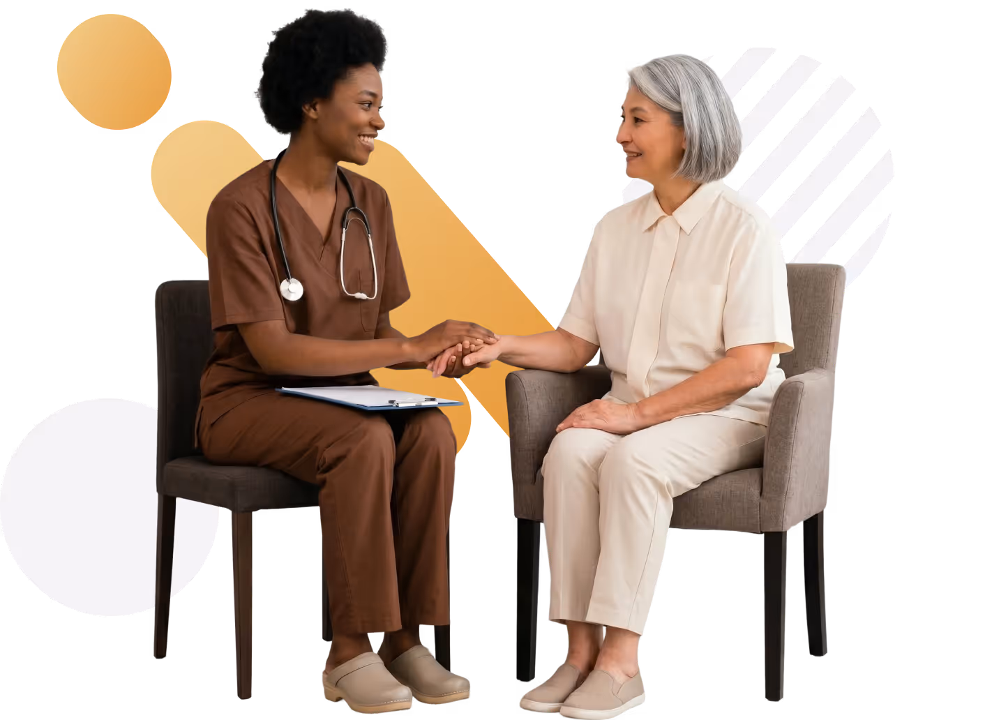 Smiling nurse holding hands and talking with elderly woman seated in chairs.