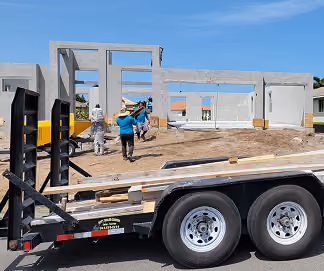 Workers assembling precast concrete panels at a construction site by MT Construction Group Miami