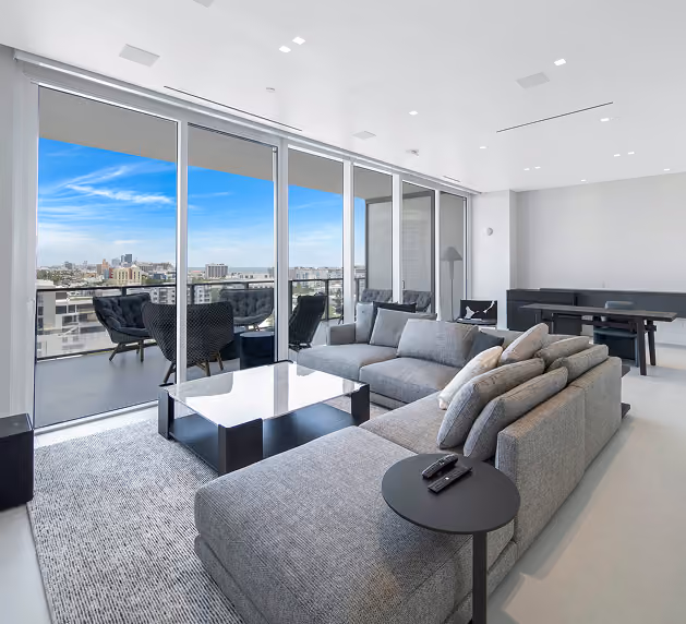 Modern living room with gray sectional sofa,  by MT Construction Miami