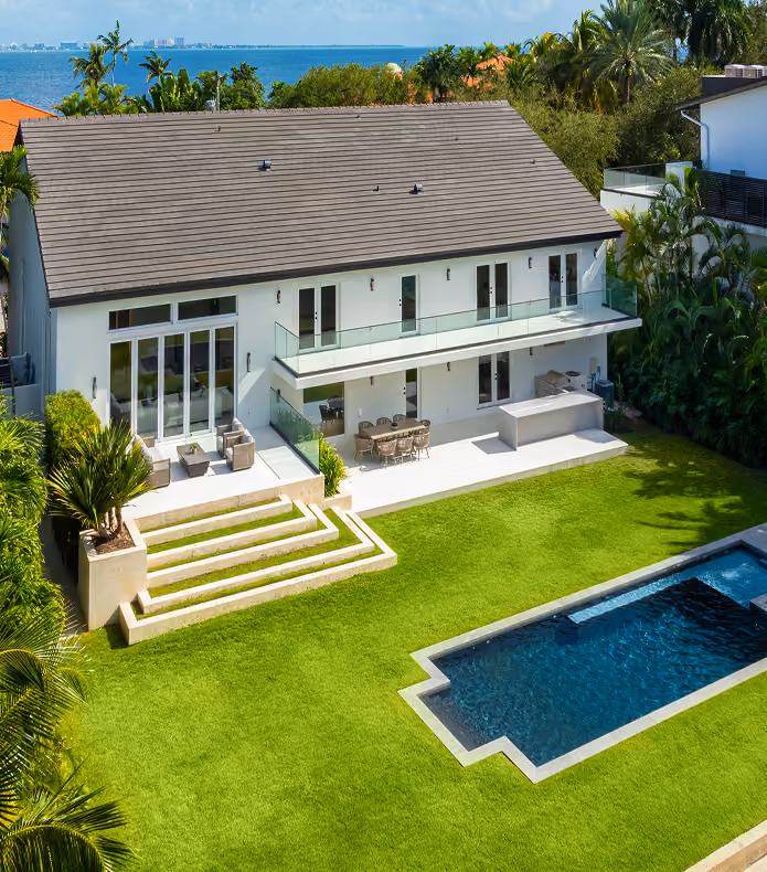 Modern two-story house with glass balcony,  by MT Construction Miami