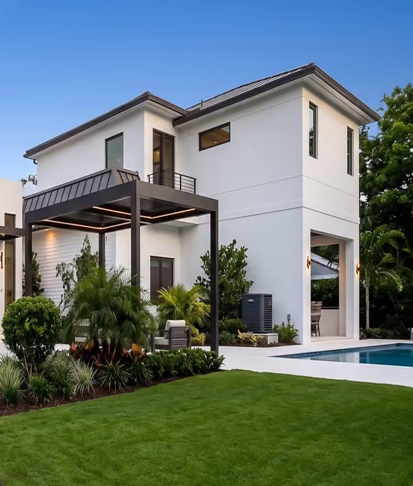 Modern two-story white house with a patio, garden,  by MT Construction Miami