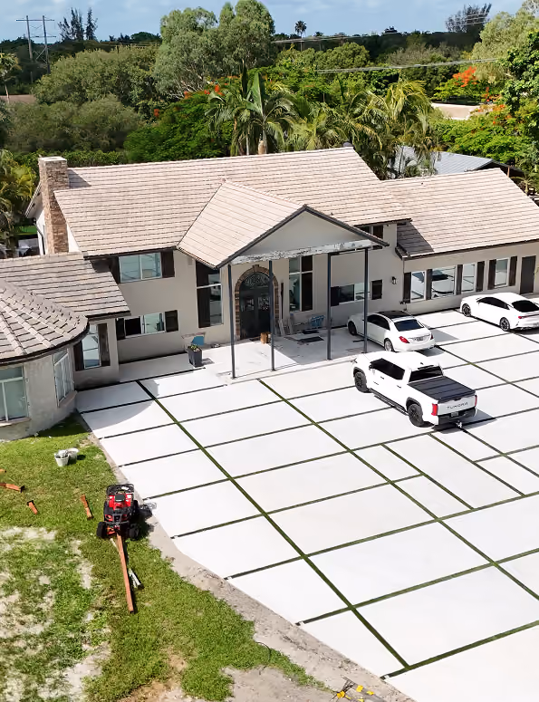 Large house with a tiled roof, surrounded by trees,  by MT Construction Miami