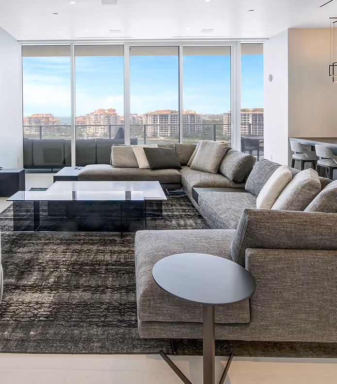 Modern living room with gray sectional sofa,  by MT Construction Miami