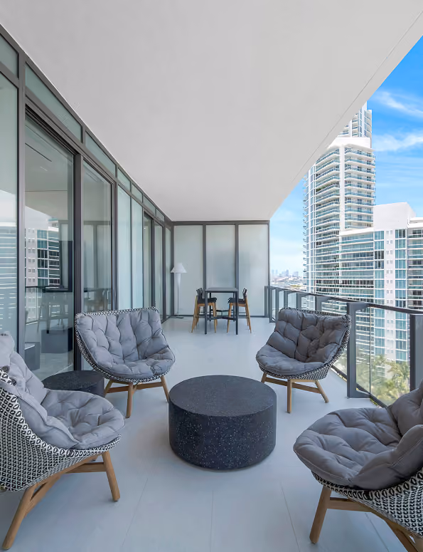 Modern balcony with four cushioned chairs  by MT Construction Miami