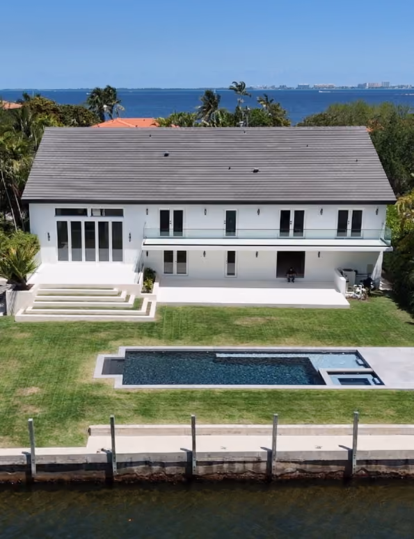 Modern white two-story house with lawn,  by MT Construction Miami