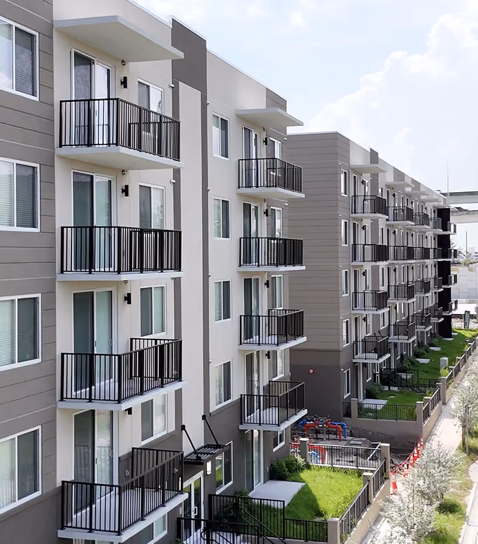 Modern multi-story apartment building with balconies,  by MT Construction Miami