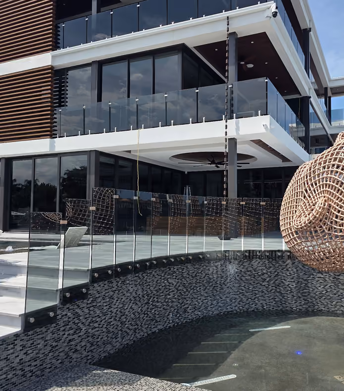 Modern building with glass balconies  by MT Construction Miami