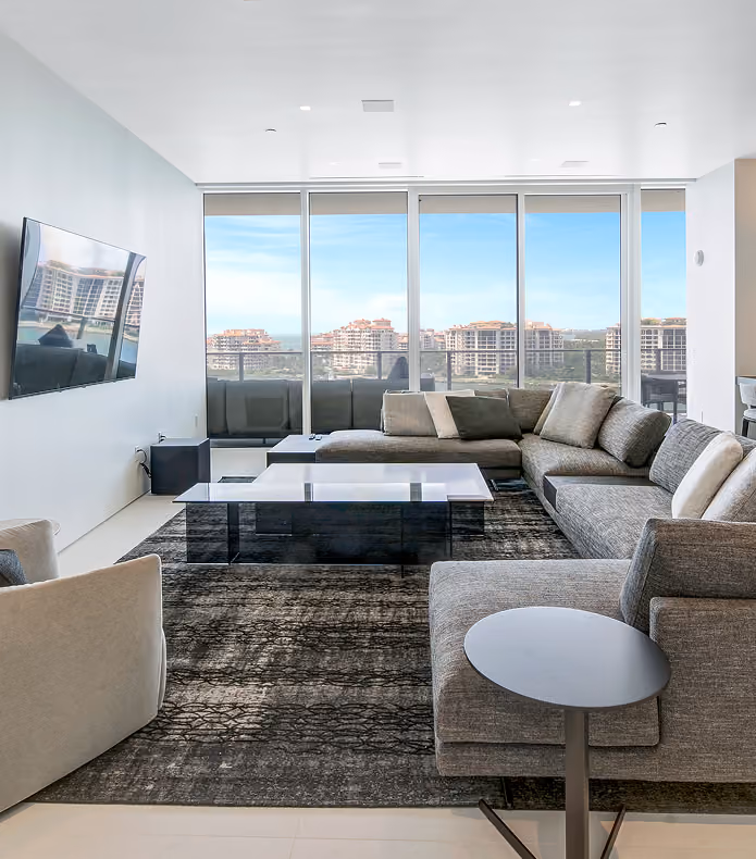 Modern living room with gray sectional sofa,  by MT Construction Miami