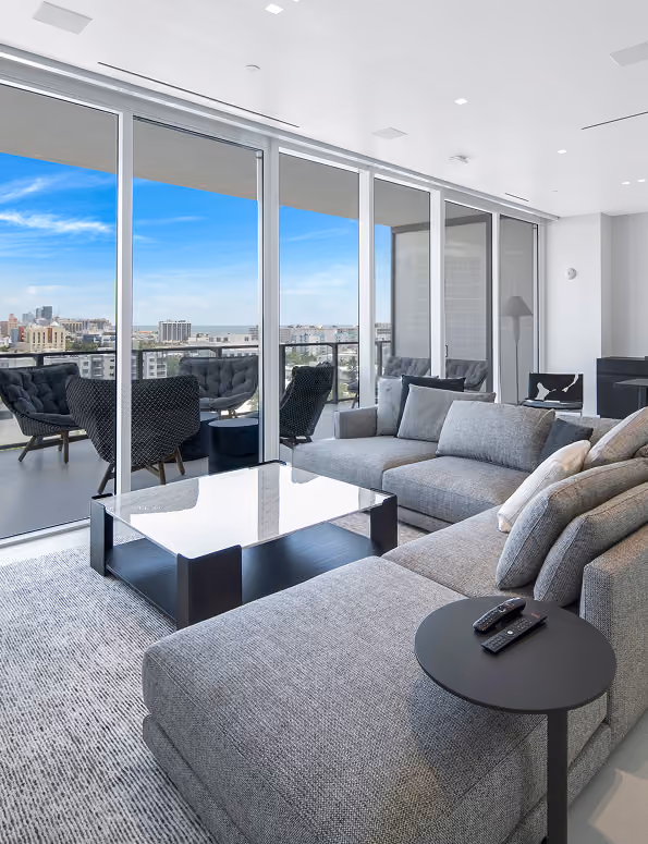 Modern living room with a gray sectional sofa,  by MT Construction Miami