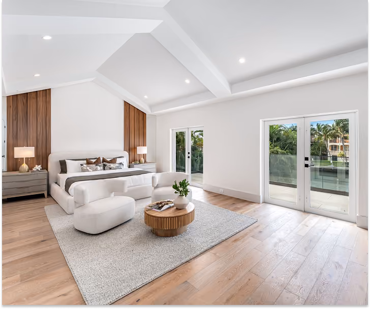 Modern bedroom with vaulted ceiling, wood floor,  by MT Construction Miami