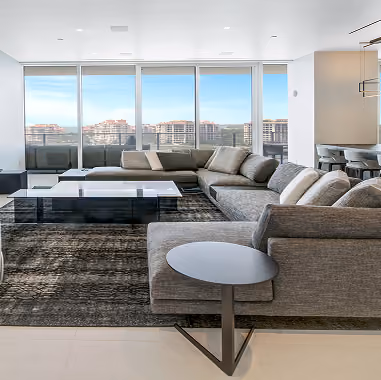 Modern living room with large gray sectional sofa,  by MT Construction Miami
