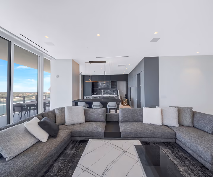 Modern living room with large gray sectional sofa, by MT Construction Group Miami