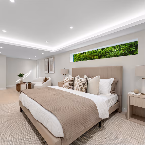 Bright bedroom with beige bed, patterned pillows, by MT Construction Group Miami