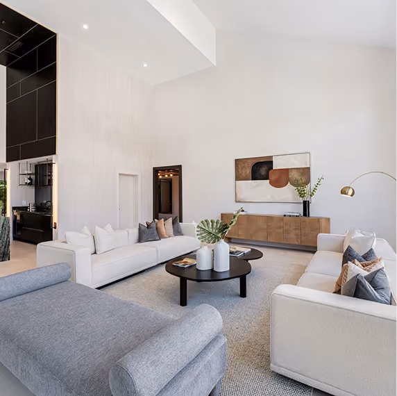 Modern living room with two cream sofas, gray chaise, by MT Construction Group Miami