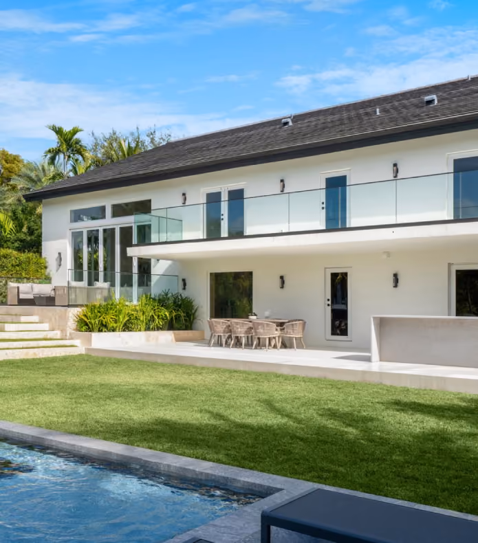 Modern two-story house with glass balcony,  by MT Construction Miami