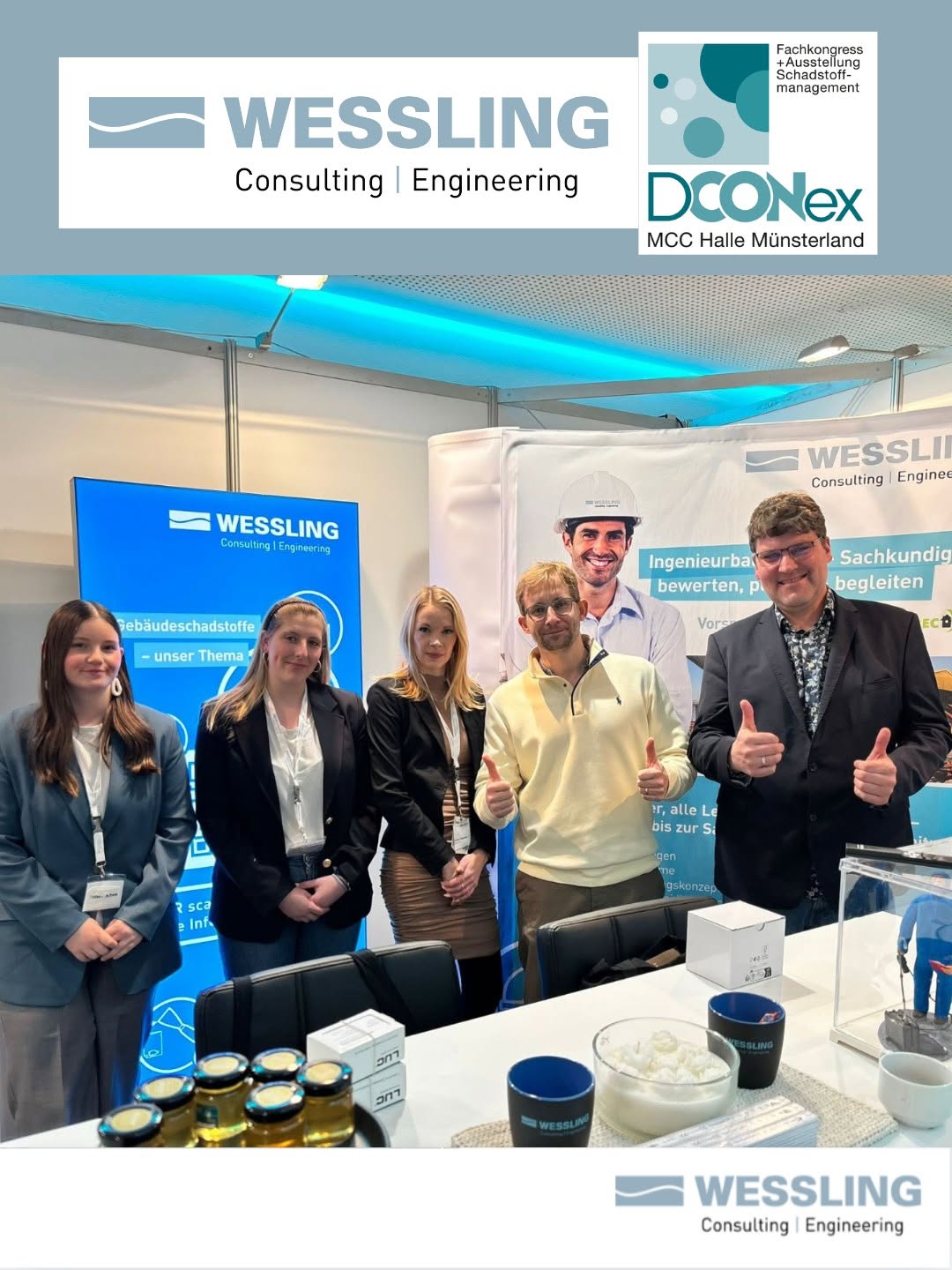 Fünf Personen stehen an einem Messestand von WESSLING Consulting und Engineering mit Infotafeln.