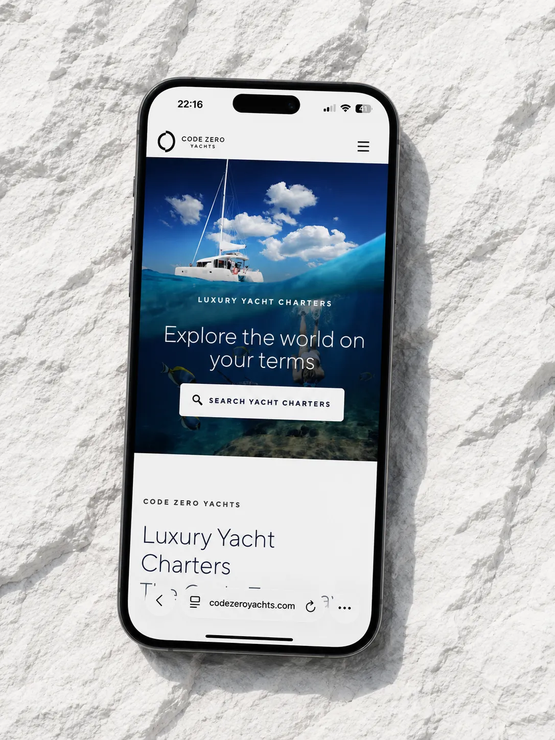 Code Zero Yachts mobile website displayed on pale stone