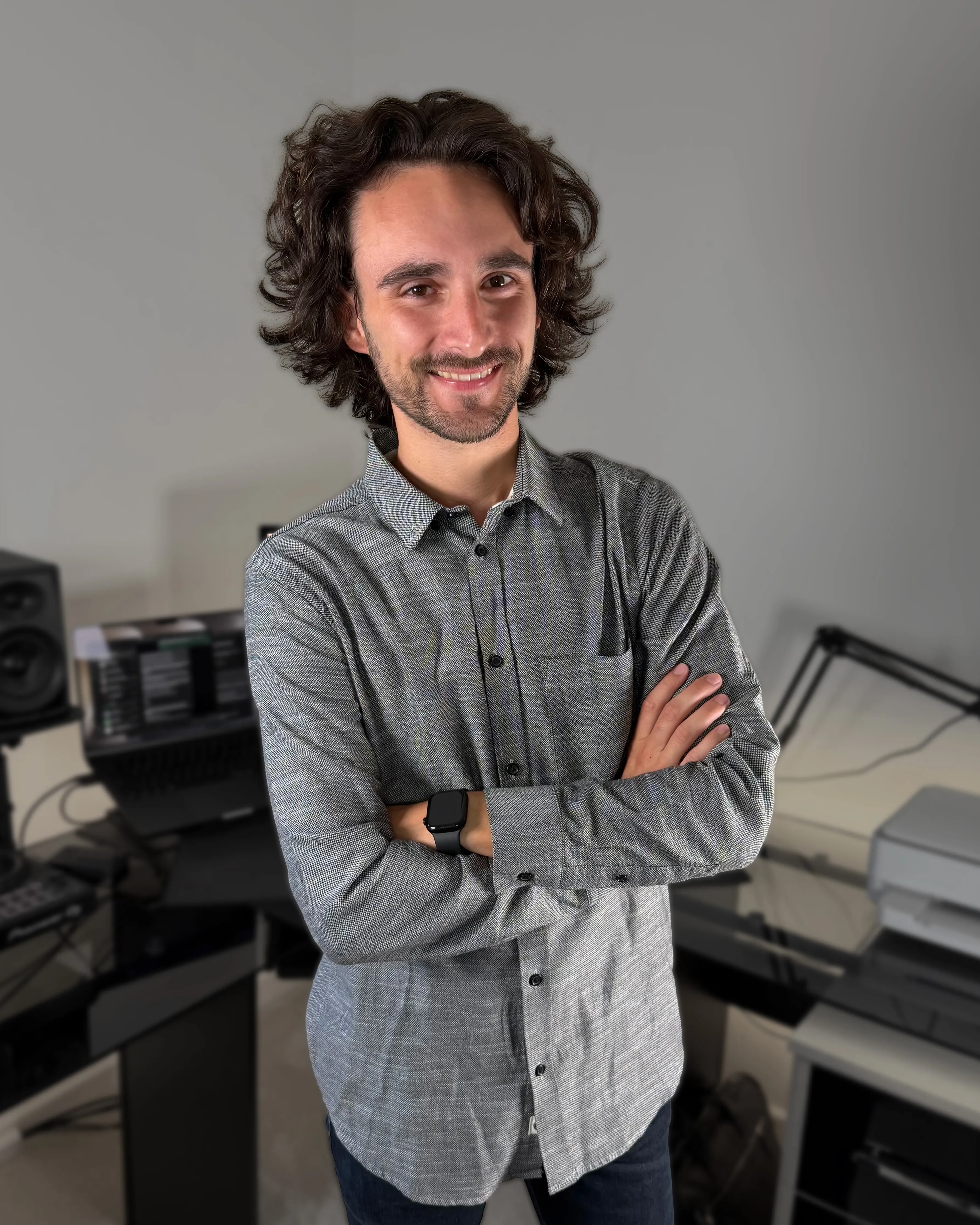 Ashley Worskett standing beside his desk