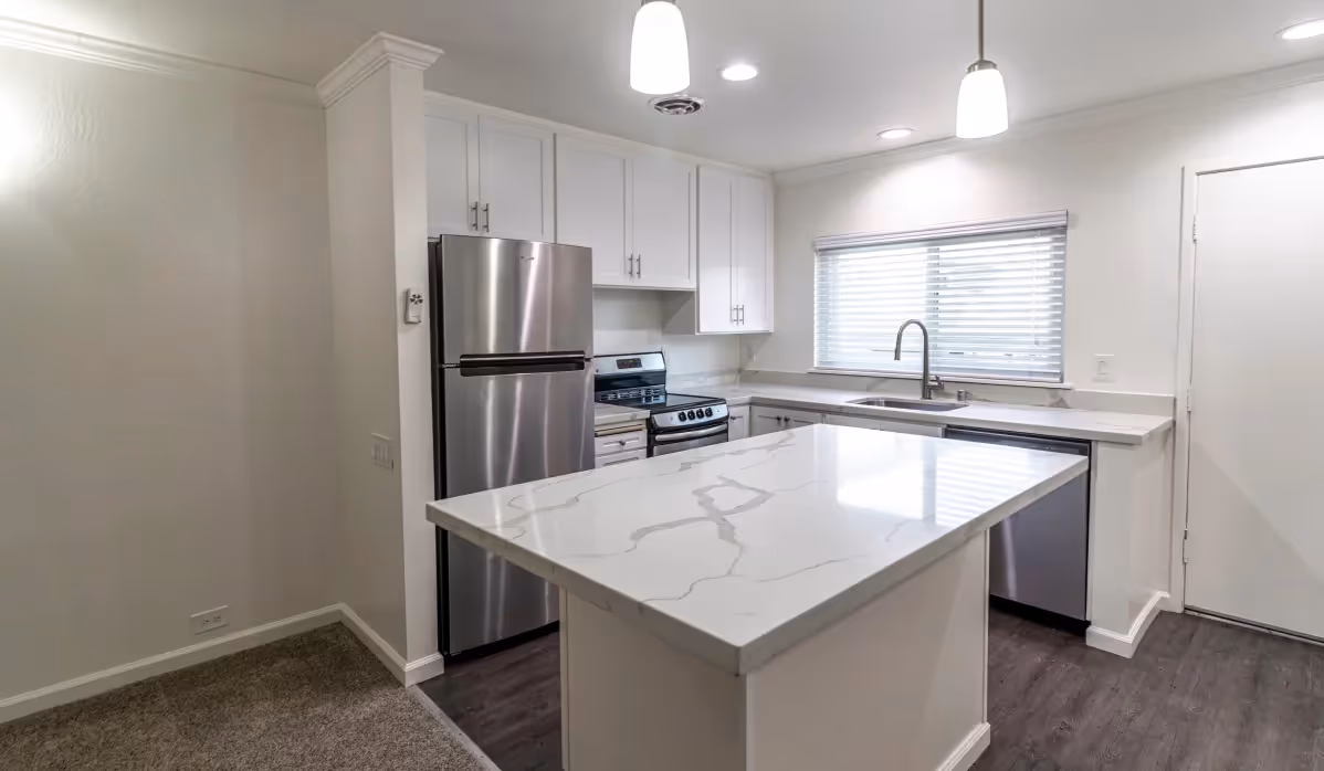 Kitchen with white cabinets and island