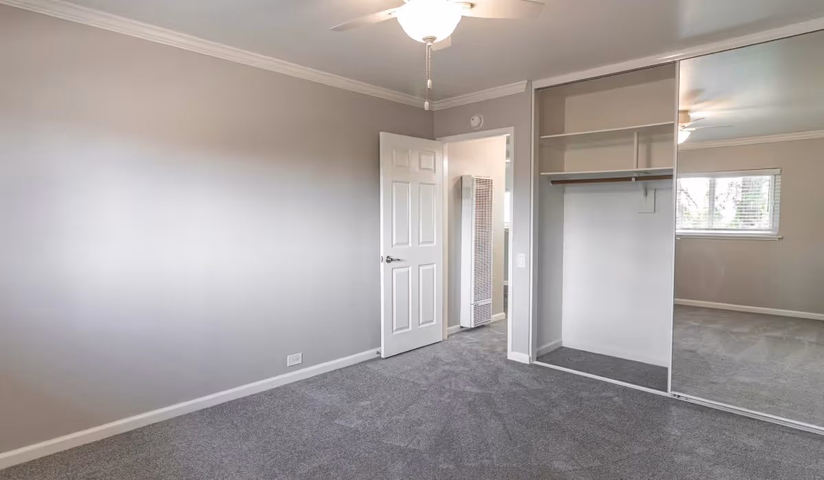 Bedroom with sliding mirror closet doors