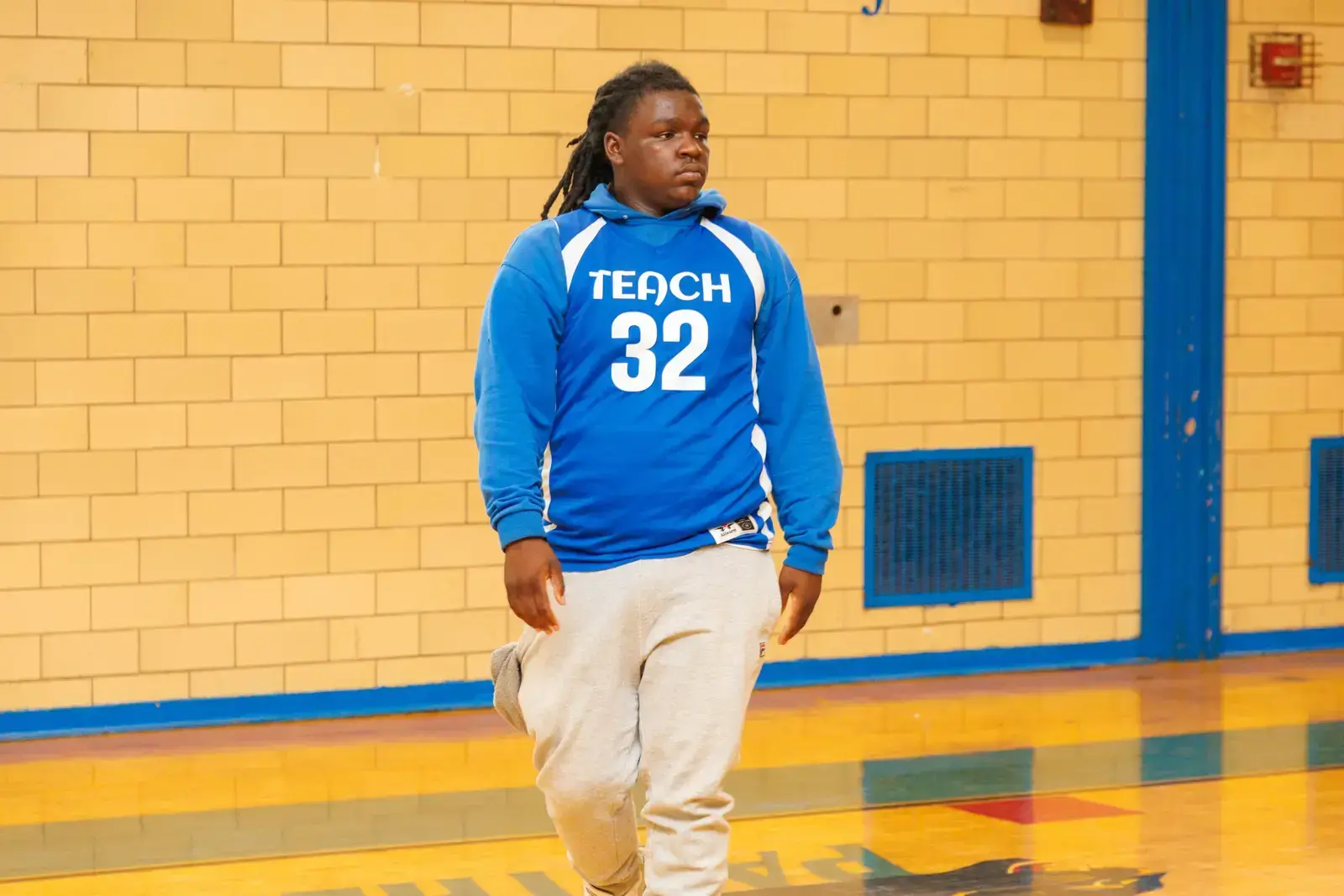 Student wearing Teach number 32 jersey in school gymnasium