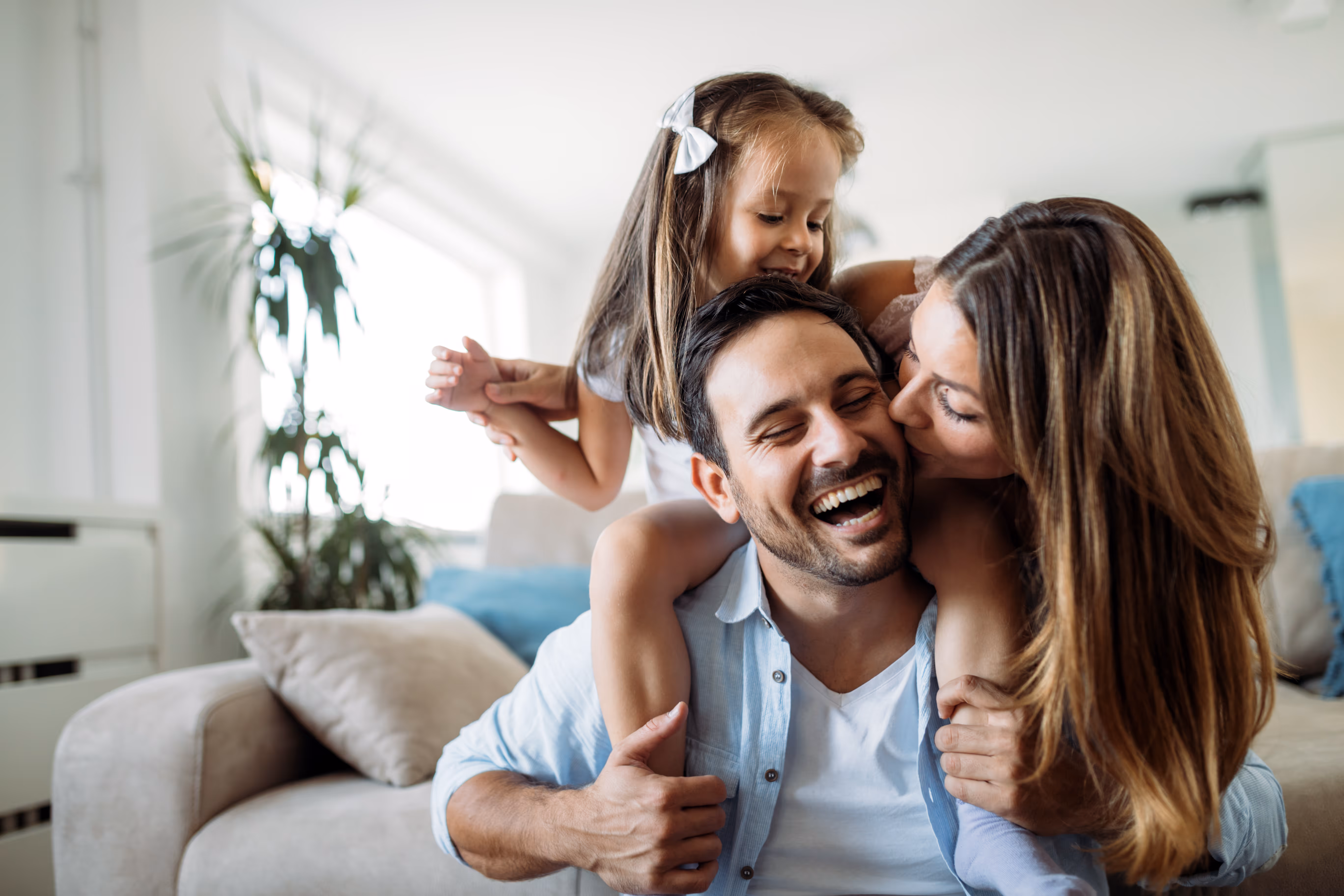 Family hugging in living room stock image