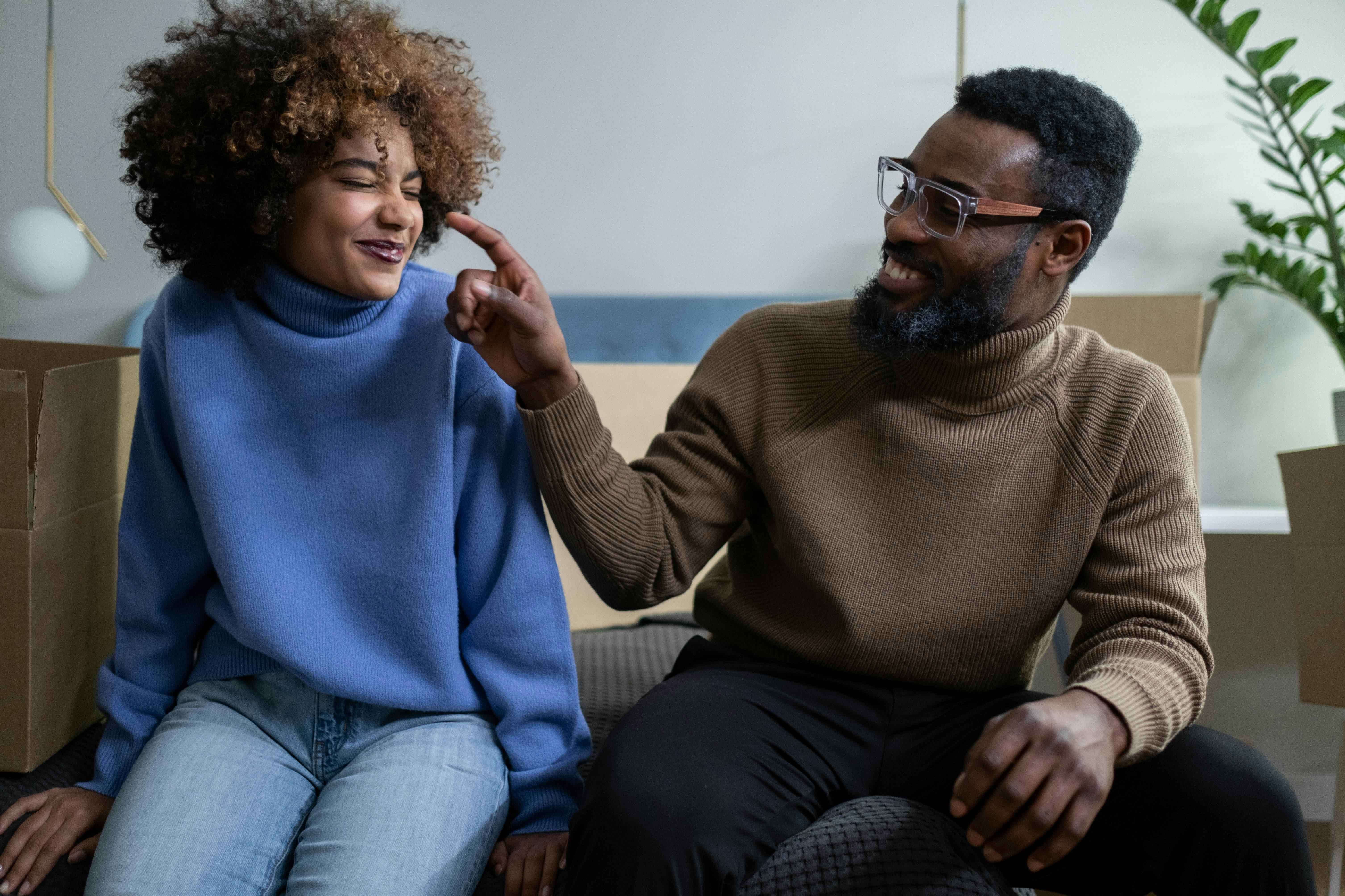 Man and woman sitting on sofa near plants stock image