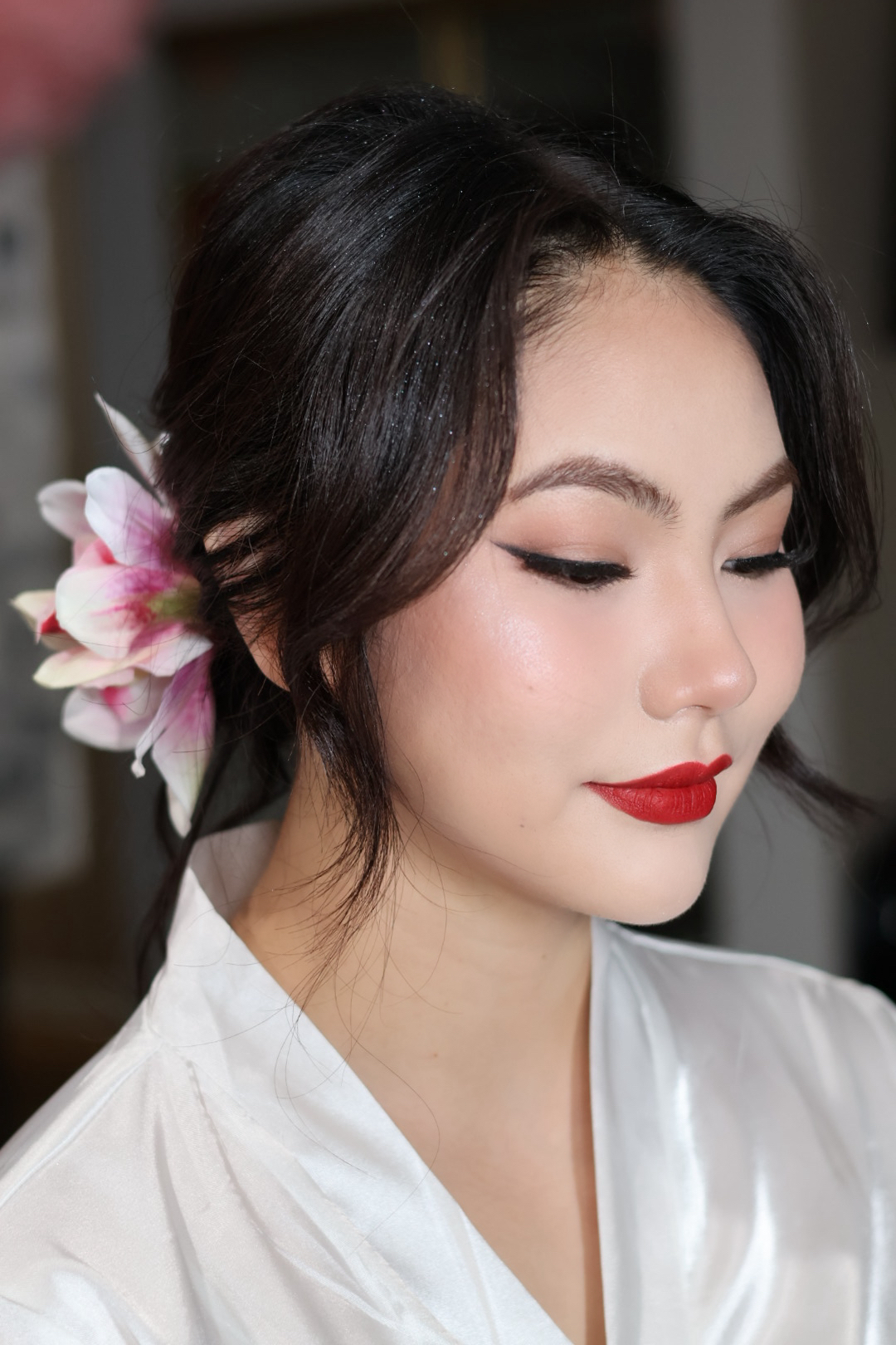 Bridal close-up makeup with red lips and floral hair accessory