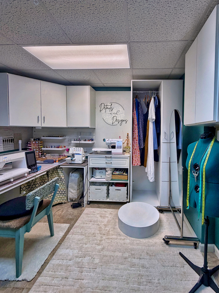 Alterations workshop with sewing machines, tools, and fabric supplies.