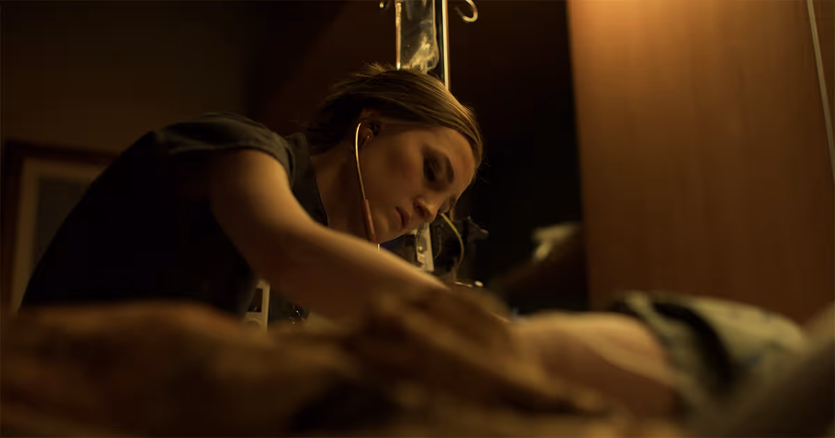 A nurse listens to the heartbeat of a patient