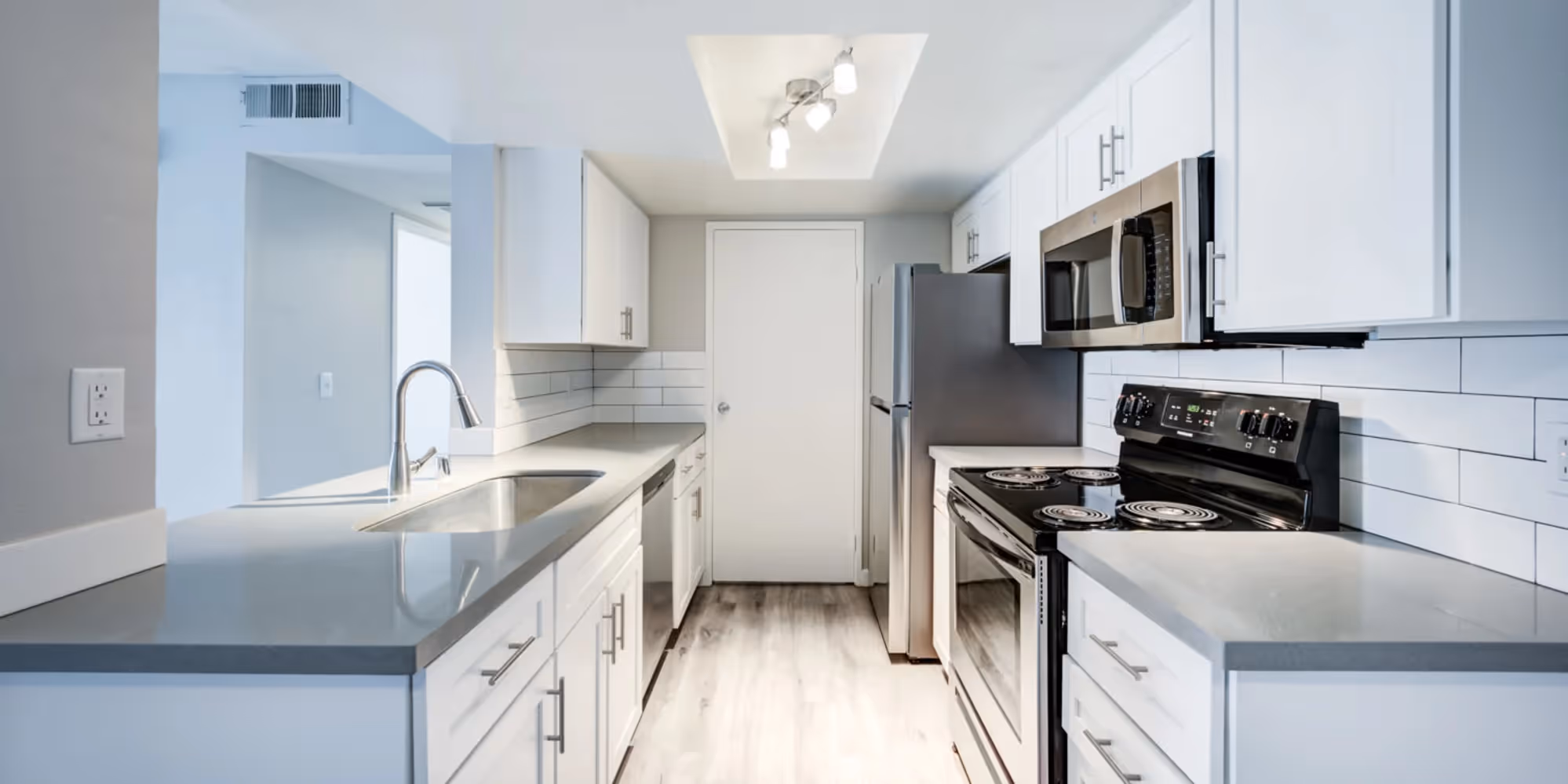 Kitchen with white cabinets and stainless steel appliances