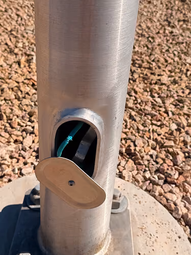 Close-up of an FLT solar light pole base, showing the internal compartment with no copper wiring inside