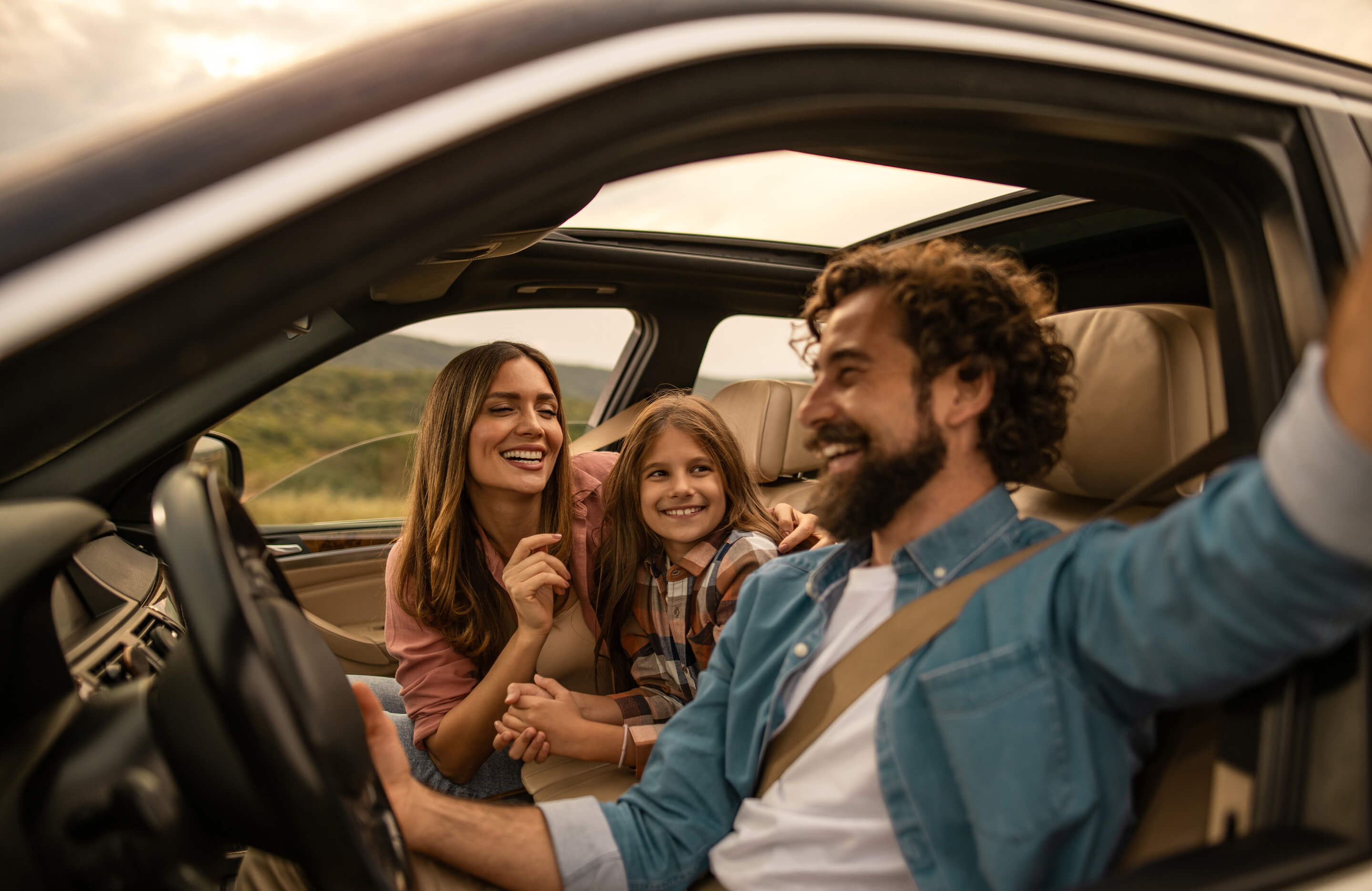 family smiling and having fun on road trip