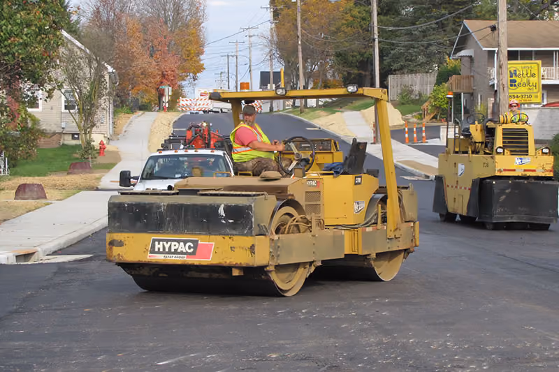 Northstar Asphalt crew compacting newly installed asphalt during a municipal roadway paving project.