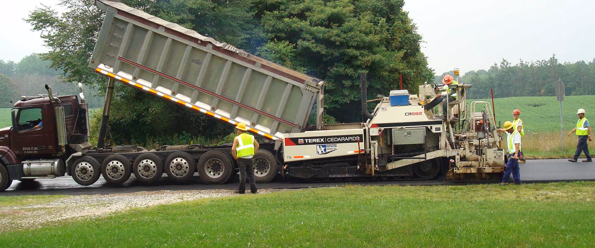 Northstar Asphalt crew working together to place fresh asphalt during a commercial roadway paving project.