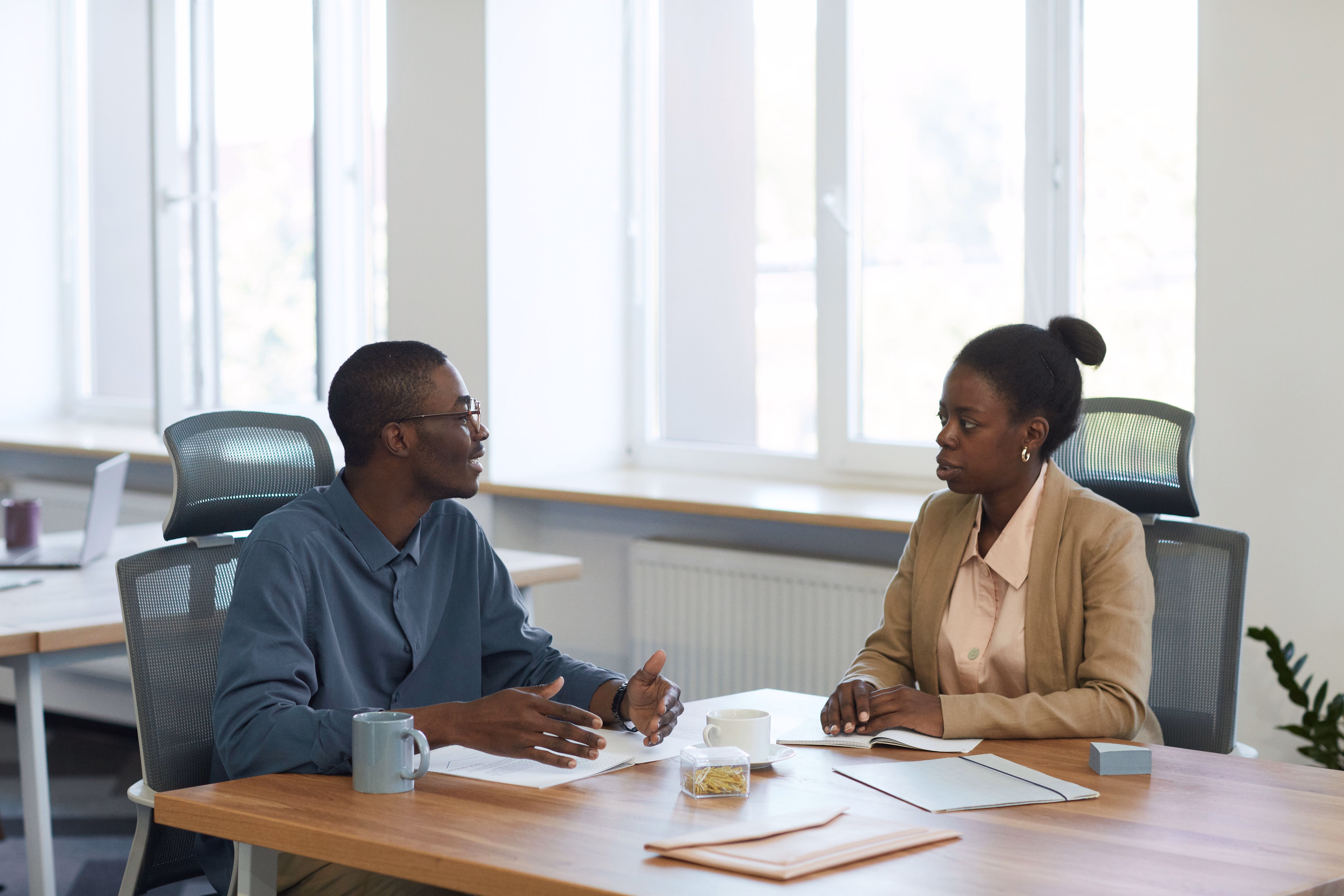 Two people talking in a meeting