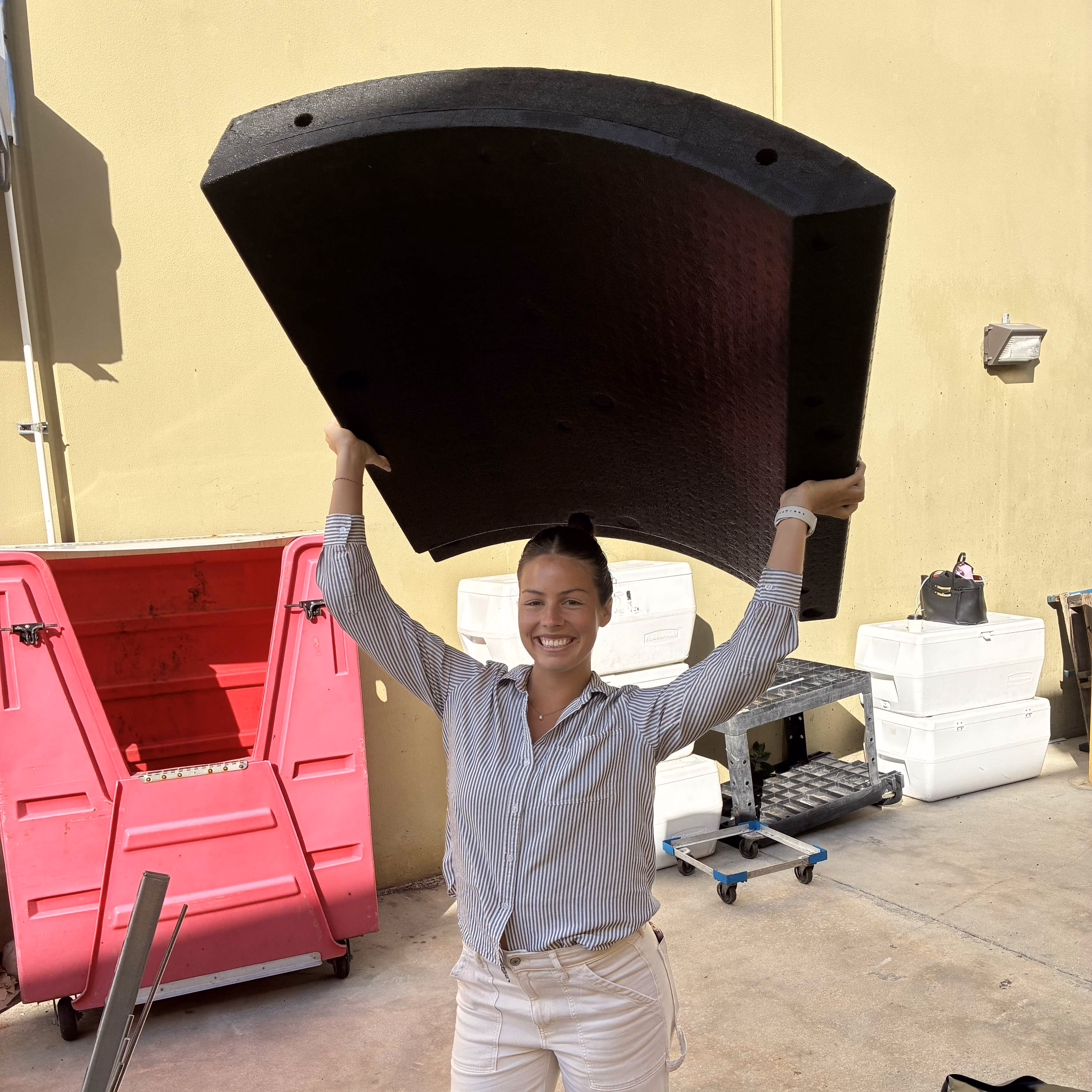 Thermal Energy HQ engineer holding a single Thermal Tank panel overhead